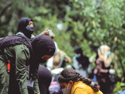 people in yellow jacket and black backpack